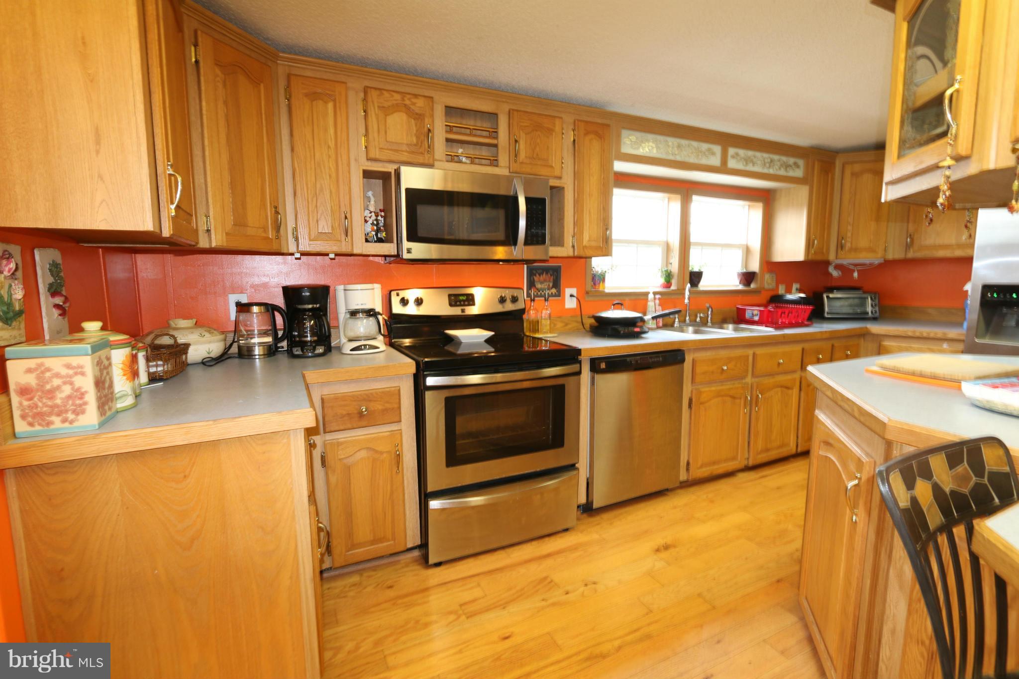 24709 Raven Rock Road Smithsburg, MD 21783 - Photo 4 of 20 a kitchen with stainless steel appliances a stove a sink a microwave and cabinets