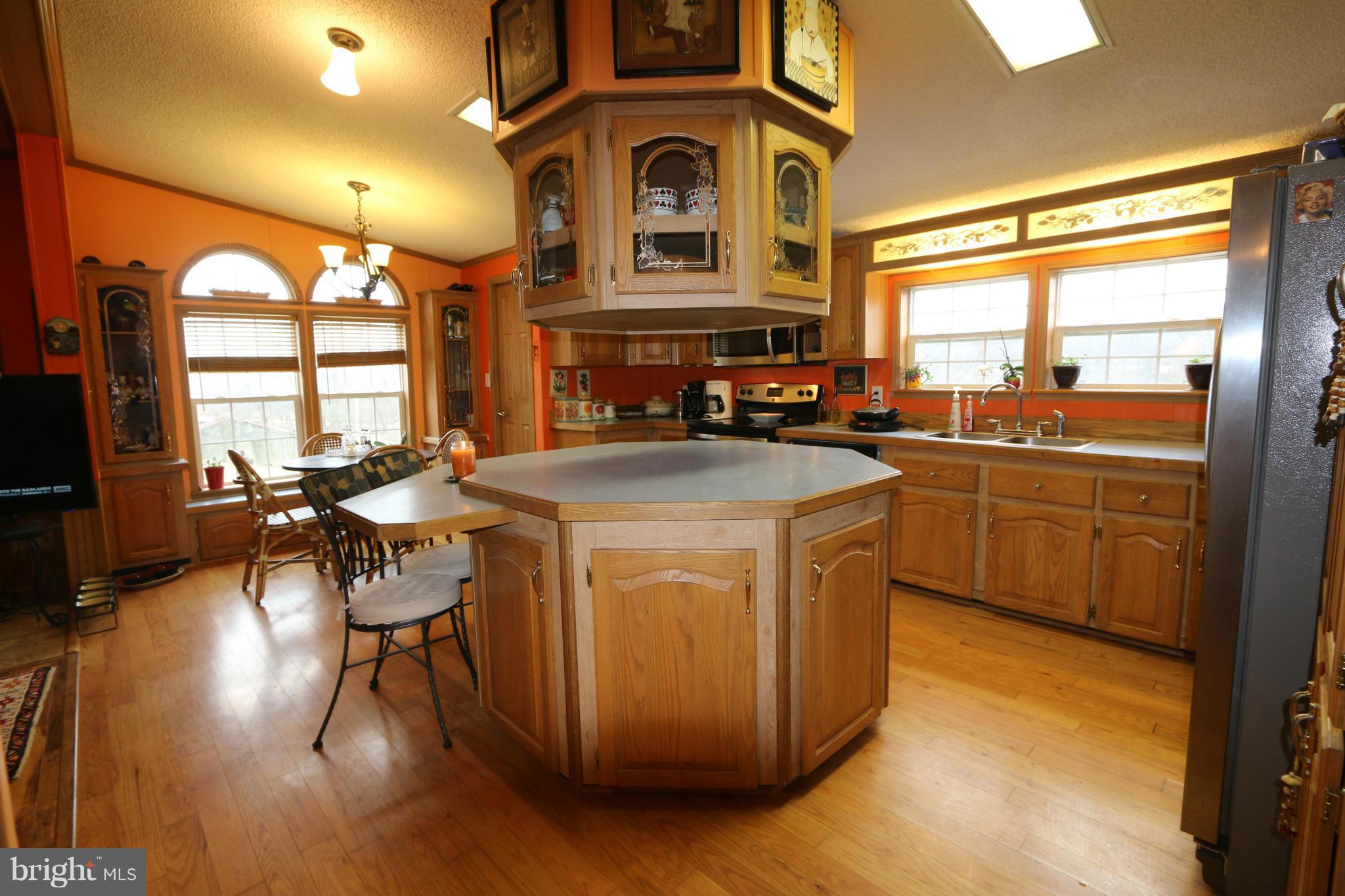 24709 Raven Rock Road Smithsburg, MD 21783 - Photo 6 of 20 a kitchen with sink a cabinets and chairs