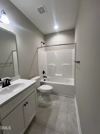 a bathroom with a granite countertop sink toilet a mirror and shower