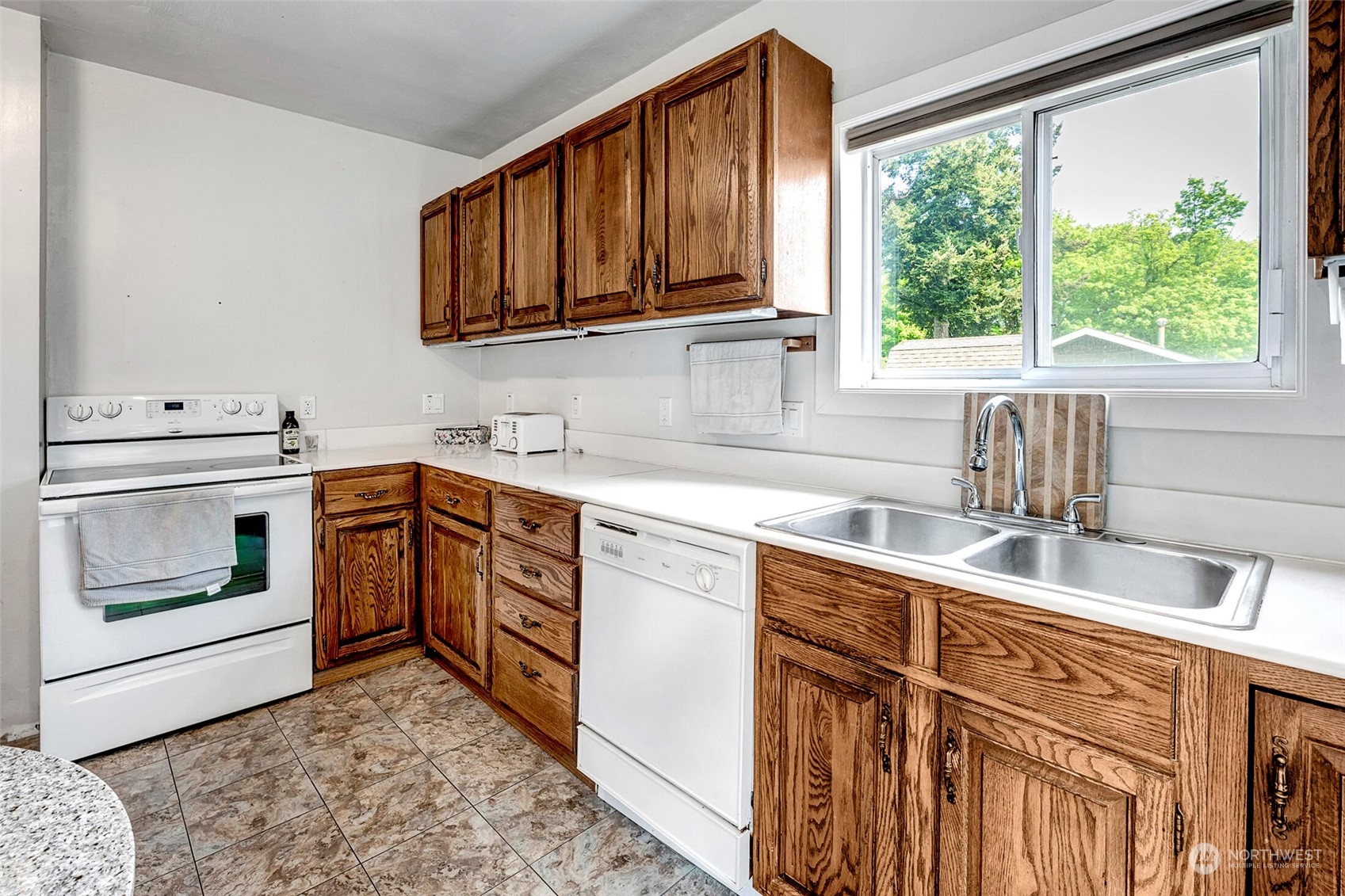 2525 Northeast 27th Street Renton, WA 98056 - Photo 8 of 30 a kitchen with stainless steel appliances granite countertop a sink stove and cabinets