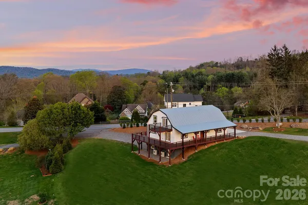 an aerial view of a house with garden space and street view