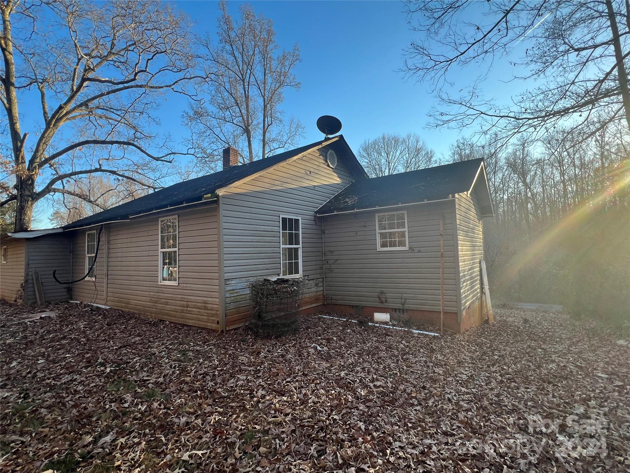 789 Groves Road Union Mills, NC 28167 - Photo 28 of 30 a backyard of a house with wooden fence and large trees