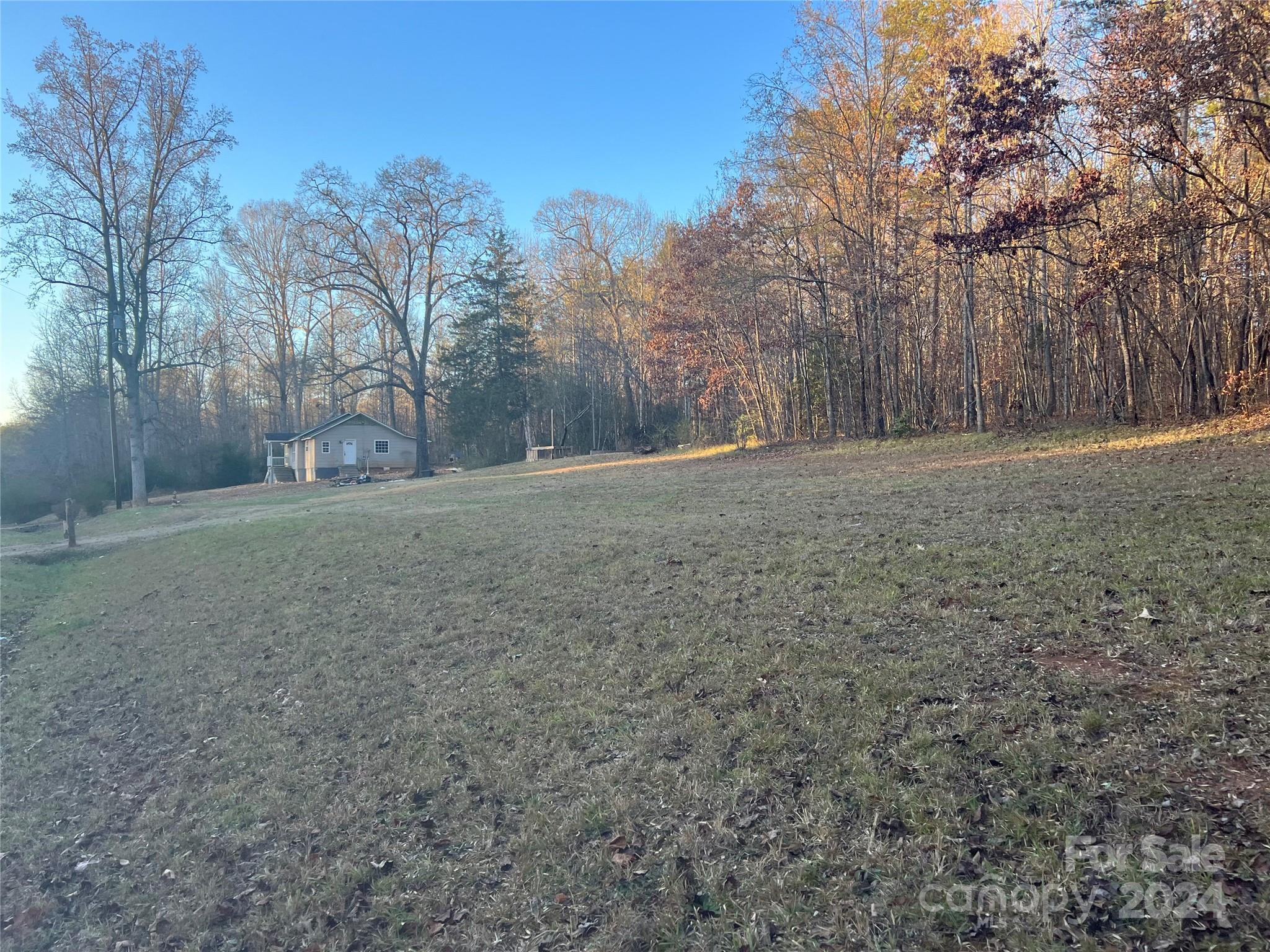 789 Groves Road Union Mills, NC 28167 - Photo 3 of 30 a view of a field with trees in the background