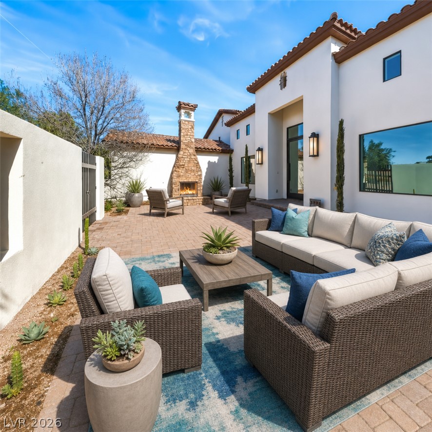 1140 Julie Road Henderson, NV 89002 - Photo 65 of 71 1140 JULIE RD HENDERSON NV 89002 Virtually staged. A spacious brick paved patio area provides a private outdoor retreat, ideal for entertaining with an inviting fireplace.