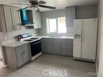 a kitchen with stainless steel appliances a sink cabinets and a window