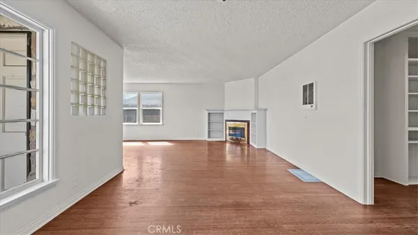 a view of livingroom with hardwood floor and kitchen view
