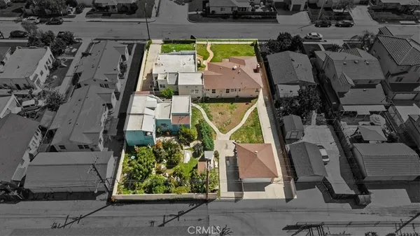 an aerial view of a house with a garden and statue