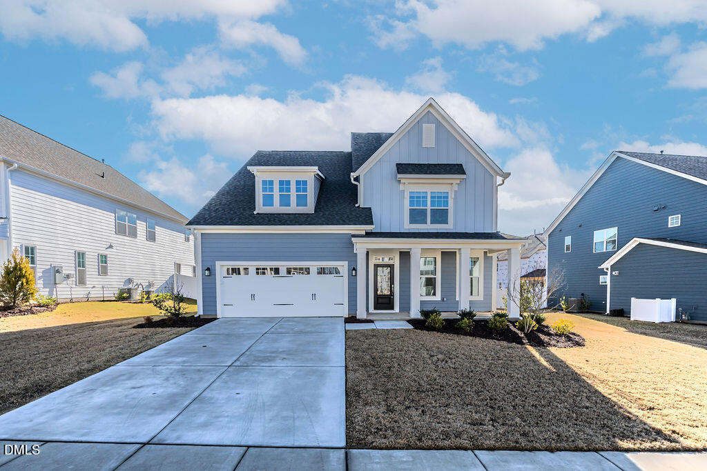 a view of a house with cars parked