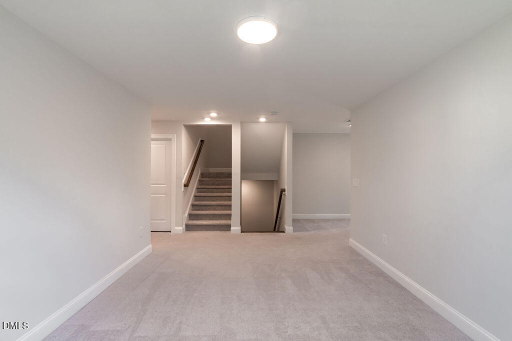 717 Ressler Street Holly Springs, NC 27540 - Photo 15 of 32 a view of an empty room with stairs
