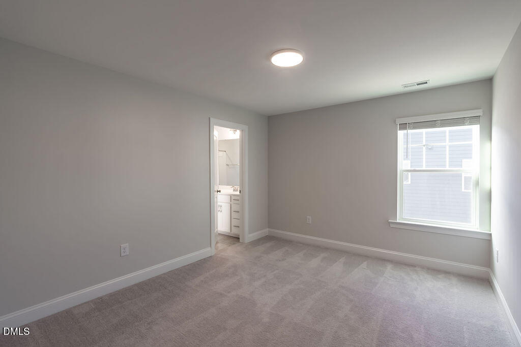 717 Ressler Street Holly Springs, NC 27540 - Photo 21 of 32 an empty room with windows