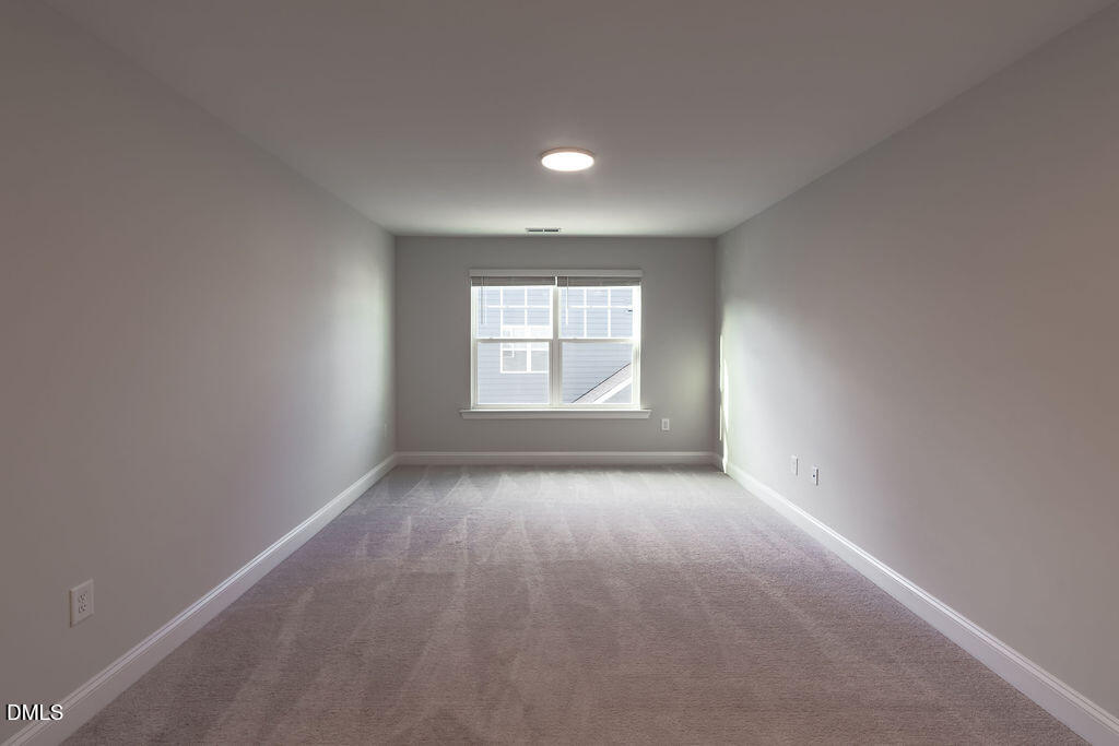 717 Ressler Street Holly Springs, NC 27540 - Photo 24 of 32 an empty room with windows