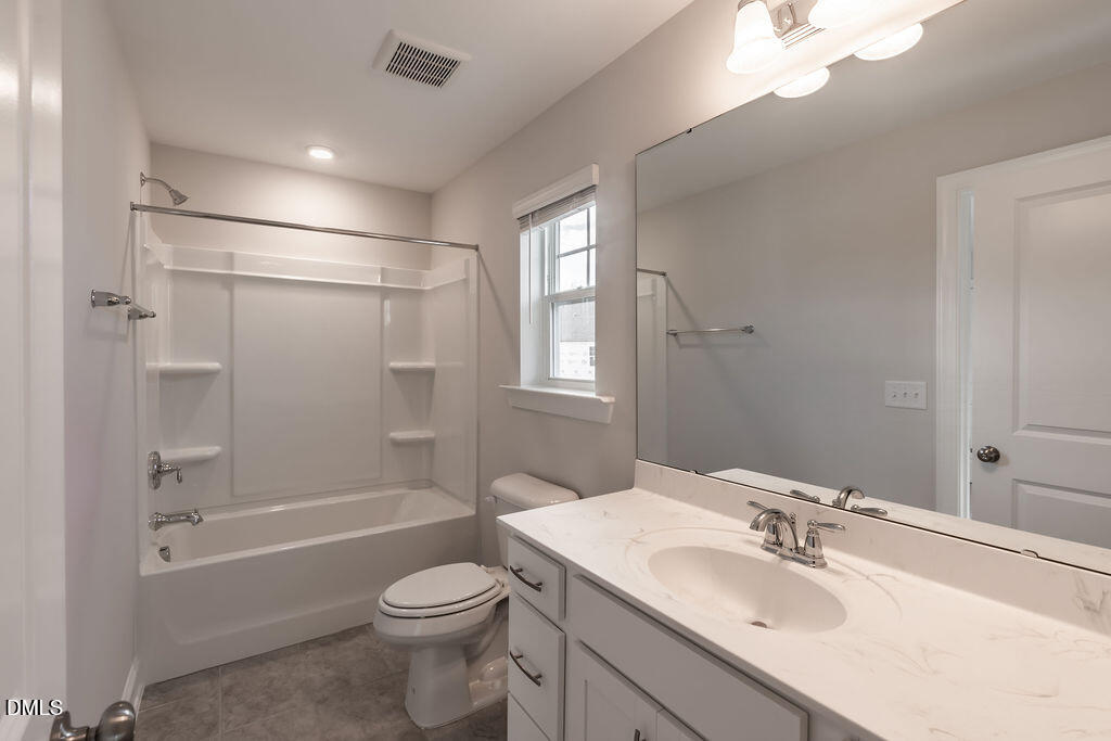 717 Ressler Street Holly Springs, NC 27540 - Photo 29 of 32 a bathroom with a sink toilet and shower