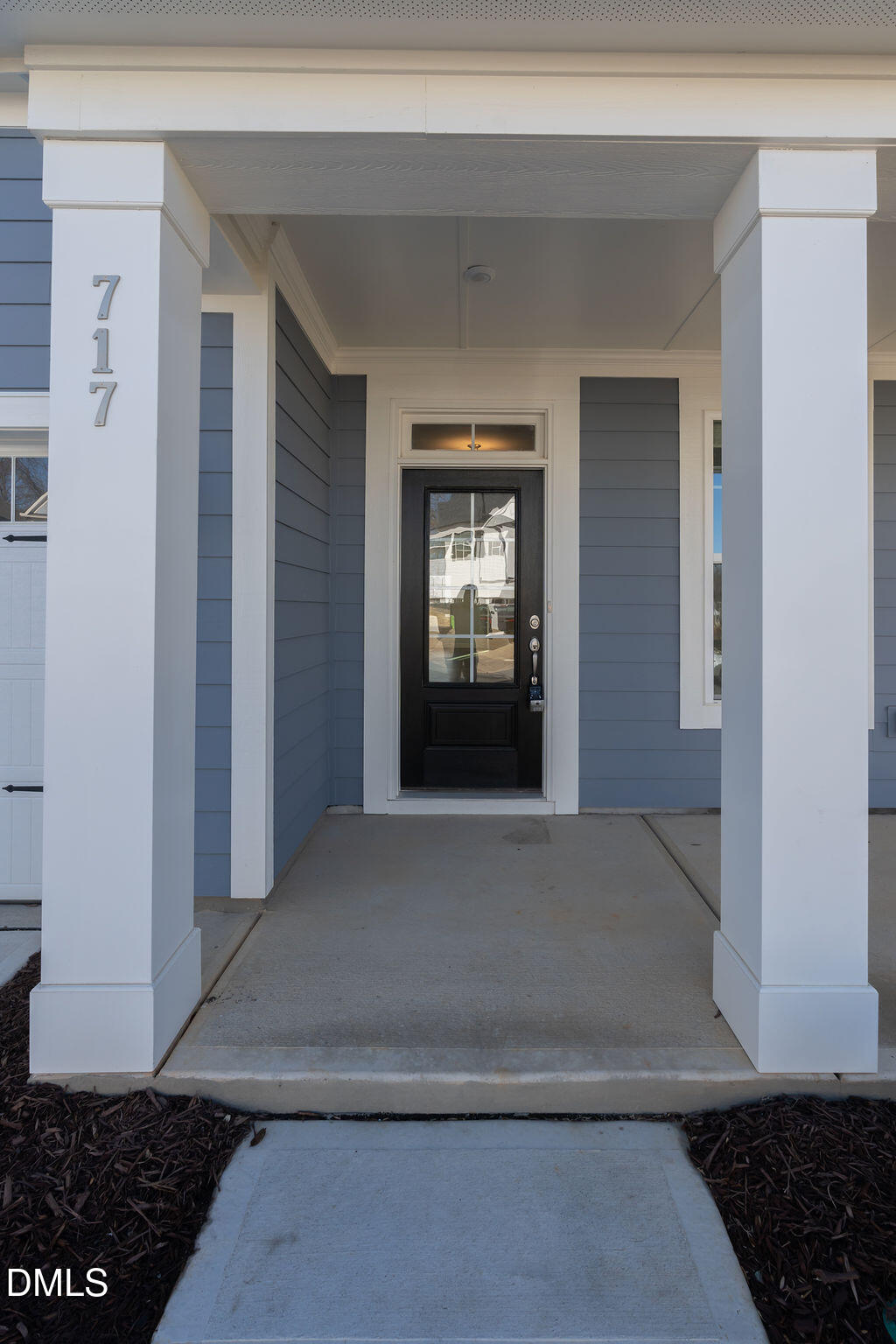 717 Ressler Street Holly Springs, NC 27540 - Photo 3 of 32 a view of a hallway with wooden floor and a living room