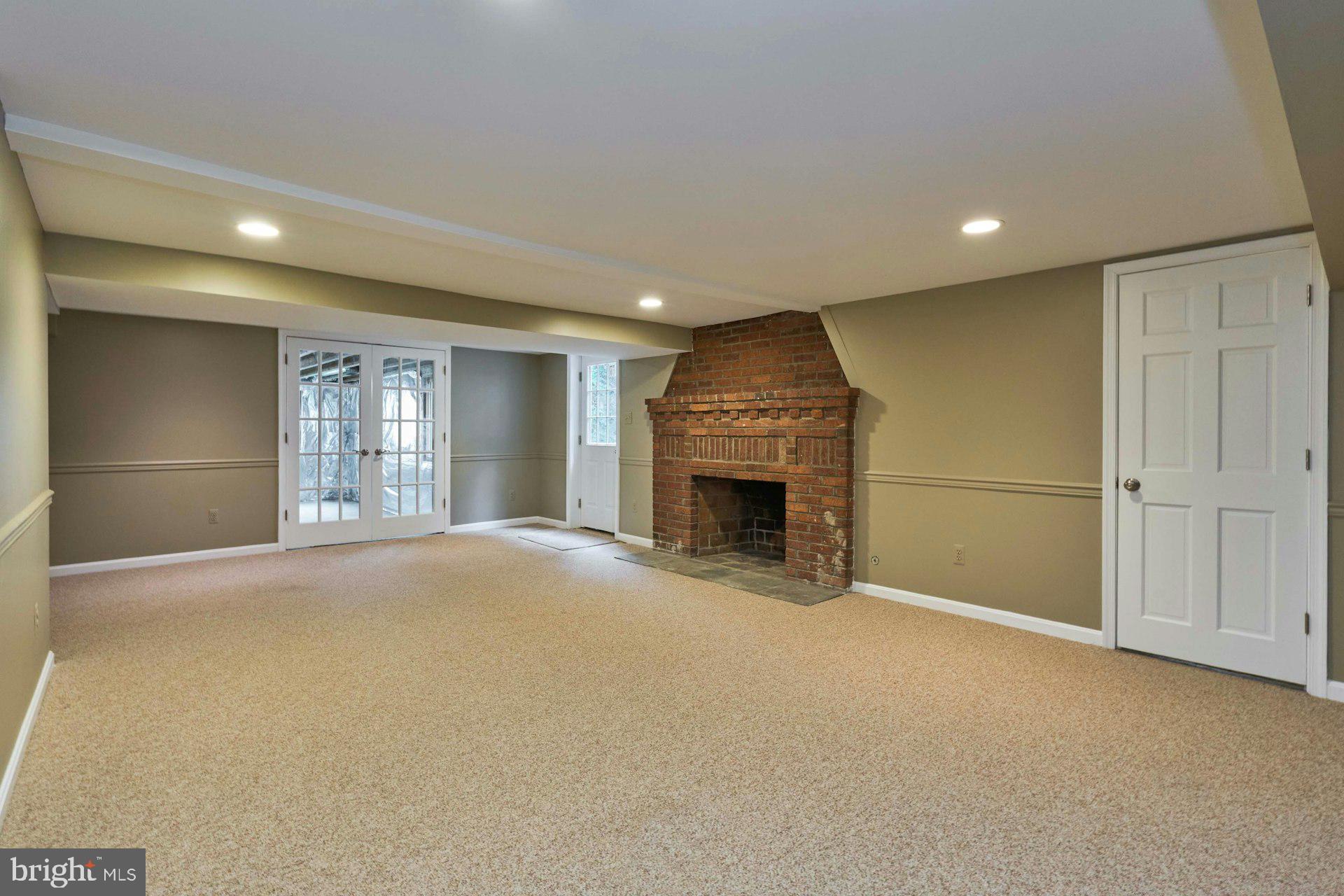 6586 Braddock Road Alexandria, VA 22312 - Photo 39 of 57 Lower Level rec room with brick fireplace