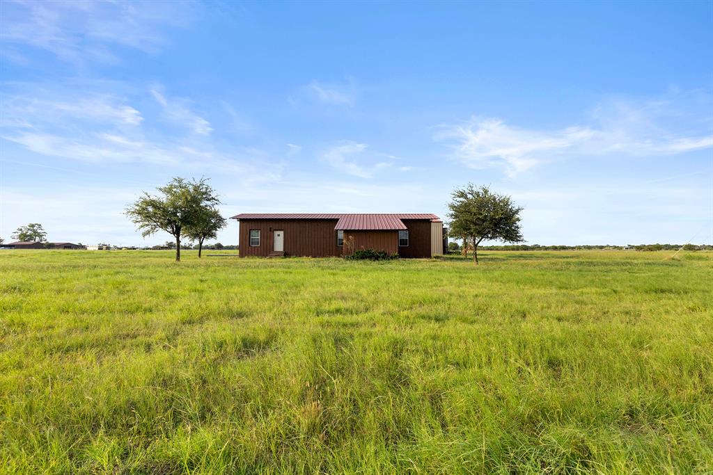 777 Stiles Road Whitesboro, TX 76273 - Photo 35 of 37 a view of an house with backyard space and trampoline