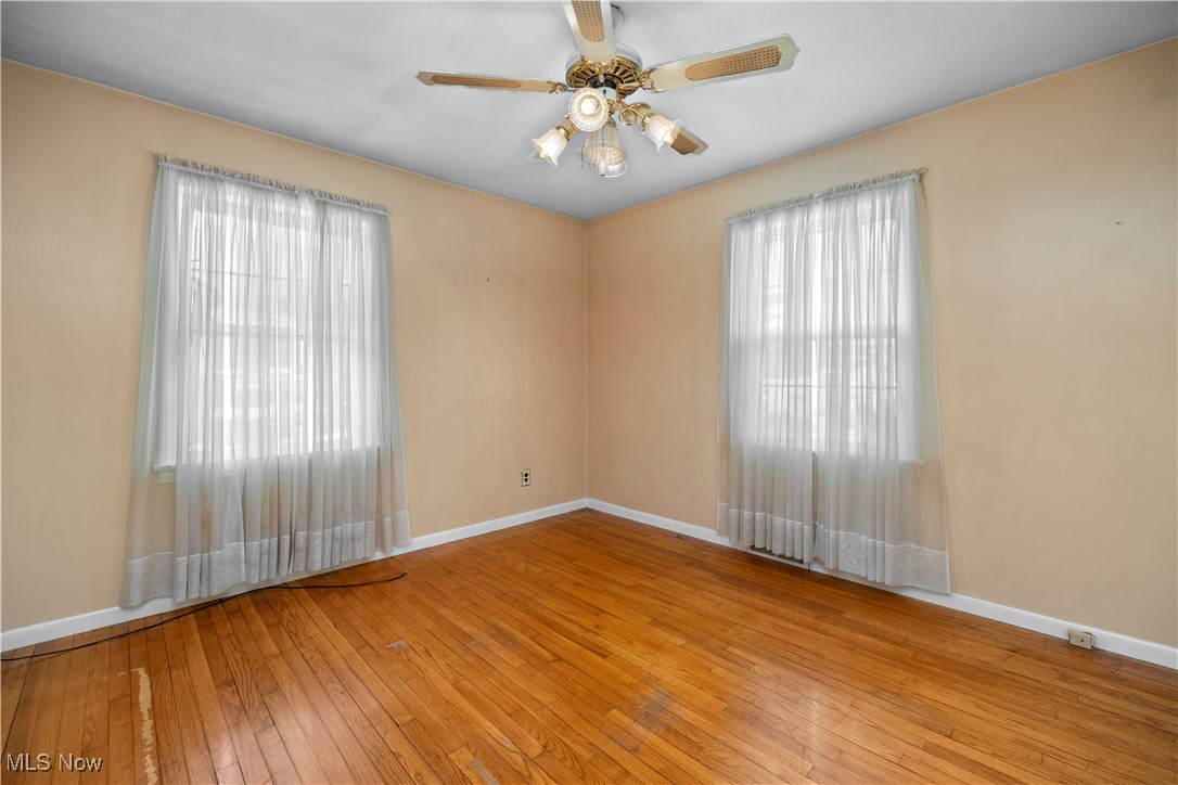 25950 Bagley Road Olmsted Falls, OH 44138 - Photo 14 of 32 Spare room with light wood-style flooring, a ceiling fan, and plenty of natural light