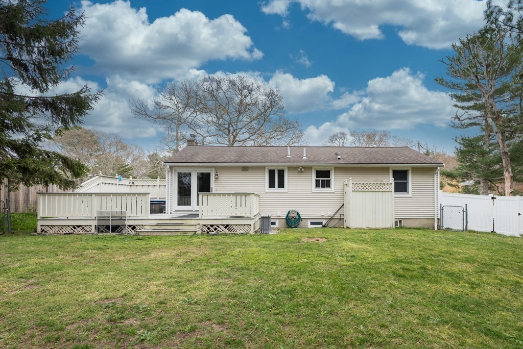 59 Cliff Road Bourne, MA 02532 - Photo 3 of 26 a view of a house with a big yard and large trees