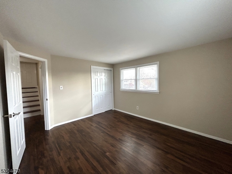 48 Glen Road Bridgewater, NJ 08805 - Photo 22 of 43 an empty room with wooden floor cabinet and windows