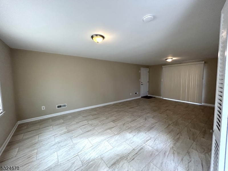 48 Glen Road Bridgewater, NJ 08805 - Photo 5 of 43 an empty room with wooden floor and windows