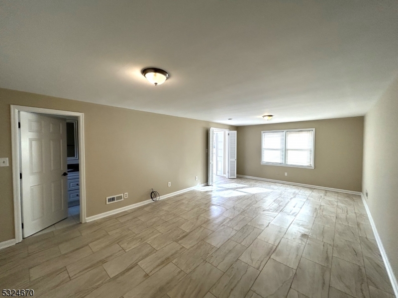 48 Glen Road Bridgewater, NJ 08805 - Photo 6 of 43 a view of an empty room with wooden floor and a window