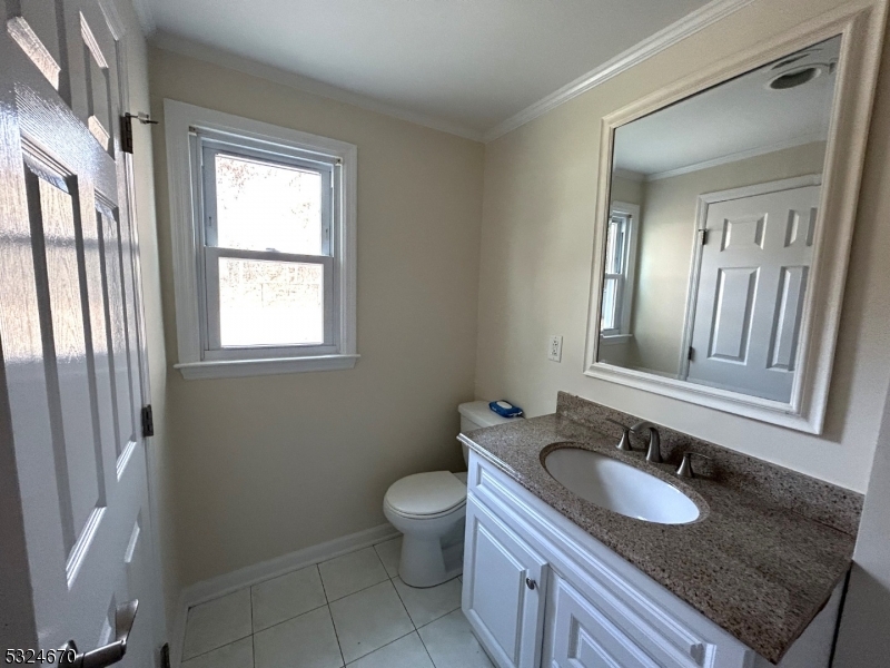 48 Glen Road Bridgewater, NJ 08805 - Photo 9 of 43 a bathroom with a granite countertop toilet a sink and a mirror