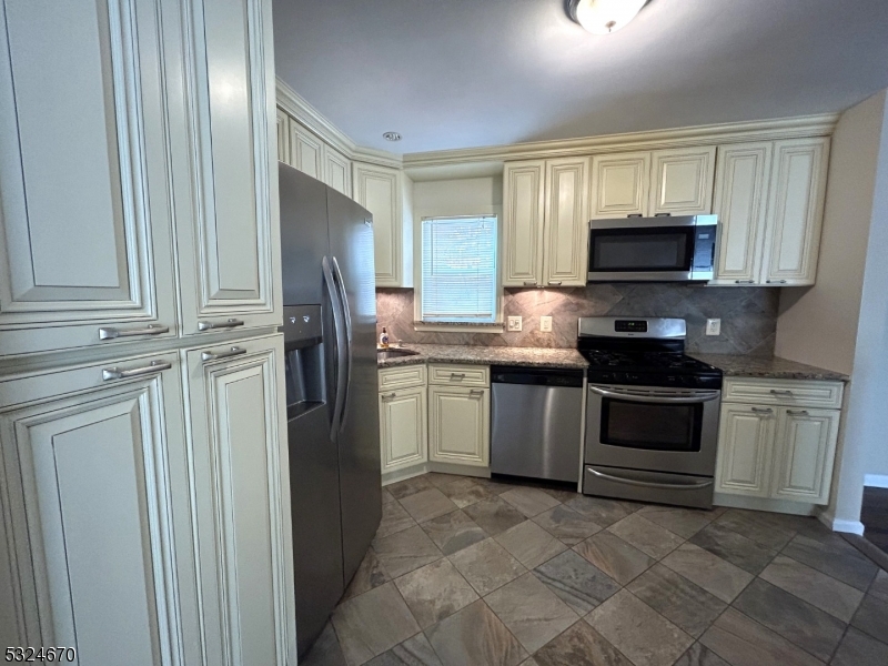 48 Glen Road Bridgewater, NJ 08805 - Photo 10 of 43 a kitchen with stainless steel appliances granite countertop a refrigerator stove a sink and dishwasher