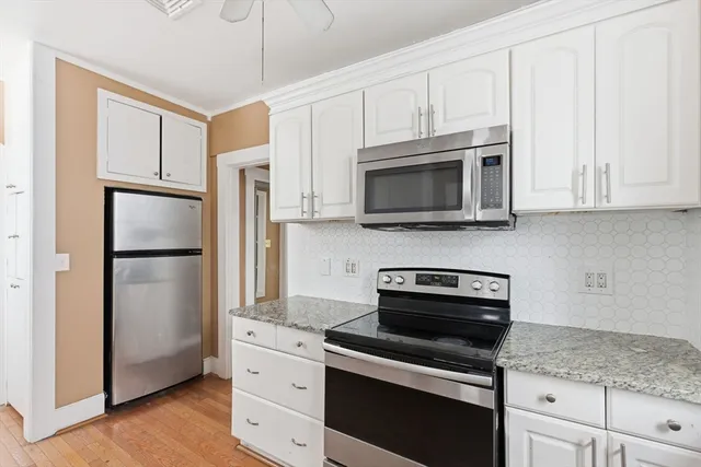 a kitchen with stainless steel appliances granite countertop a refrigerator stove and microwave