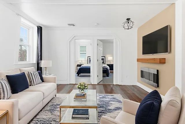 a living room with furniture fireplace and a flat screen tv