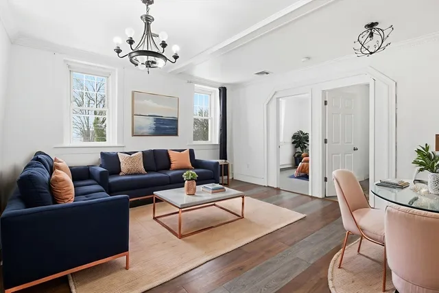 a living room with furniture and a chandelier