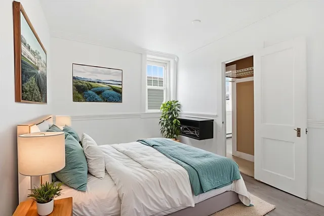 a bedroom with a bed and a lamp on the table