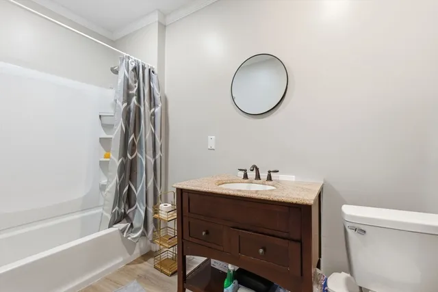 a bathroom with a sink a toilet and a mirror