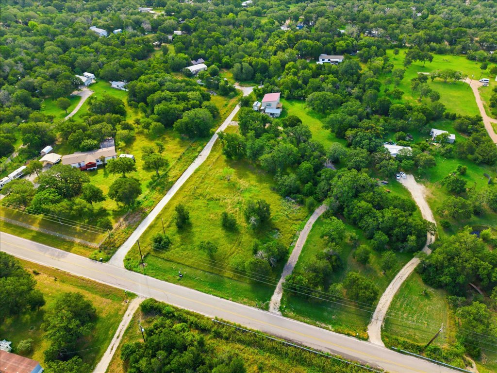 211 Webberwood Way Elgin, TX 78621 - Photo 2 of 10 Nestled among verdant trees and grassy expanses, a tranquil rural property awaits your vision.