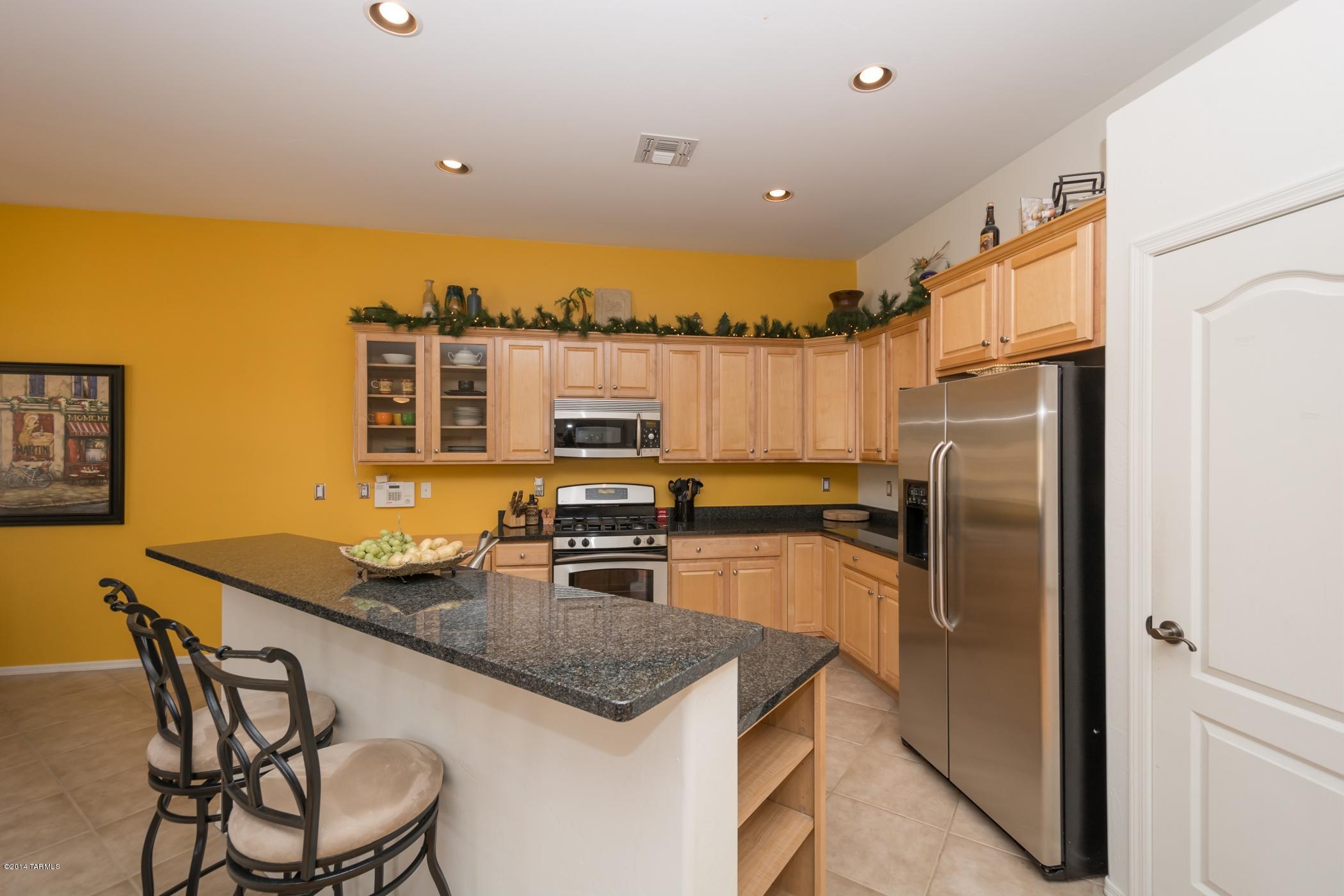 15082 North Holsteiner Road Tucson, AZ 85739 - Photo 18 of 34 a kitchen with stainless steel appliances granite countertop a sink a stove and refrigerator