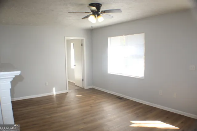 a view of hallway with wooden floor