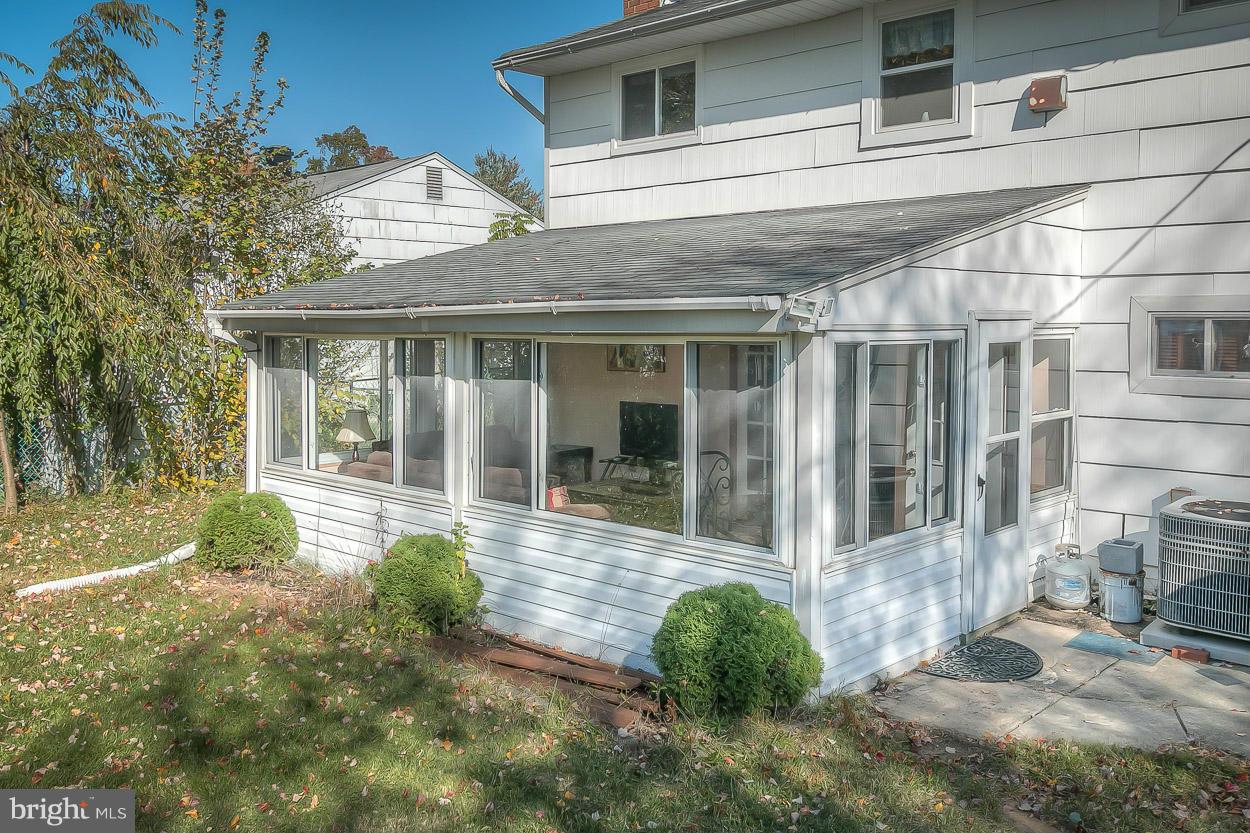 3902 Nemo Road Randallstown, MD 21133 - Photo 27 of 29 a view of a white house with a large window and potted plants