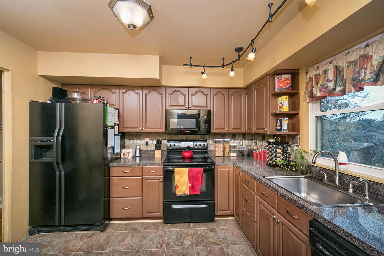 3902 Nemo Road Randallstown, MD 21133 - Photo 4 of 29 a kitchen with stainless steel appliances granite countertop a refrigerator and a sink