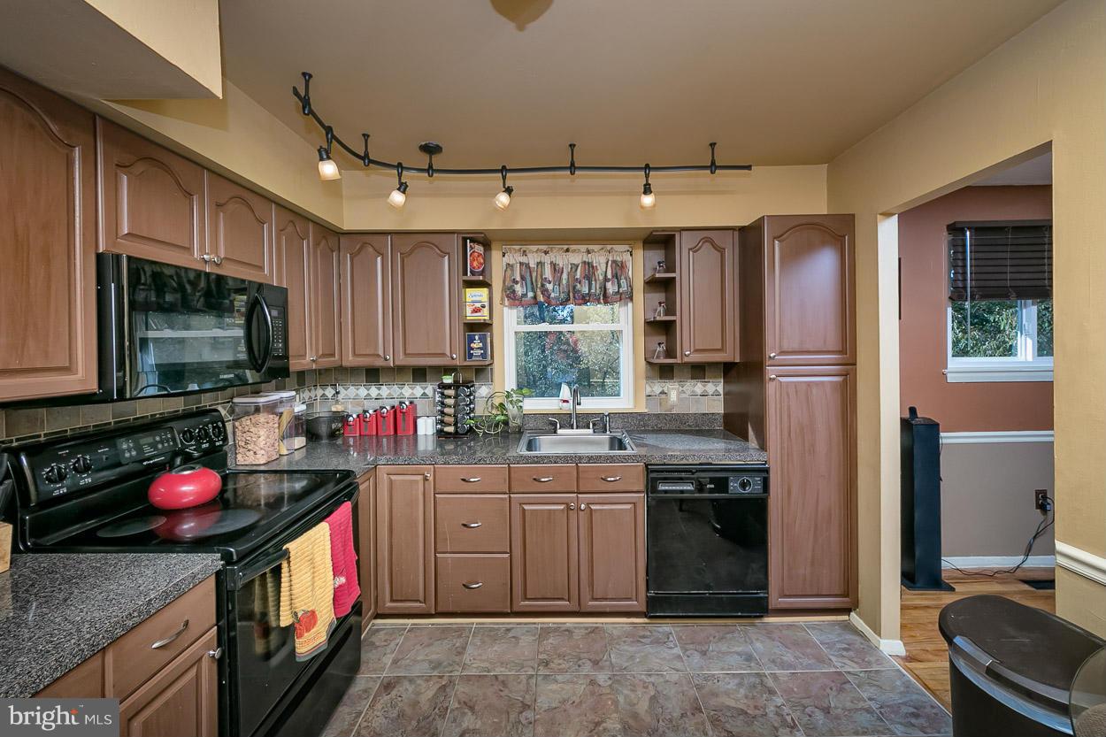 3902 Nemo Road Randallstown, MD 21133 - Photo 5 of 29 a kitchen that has a sink a stove and a stove