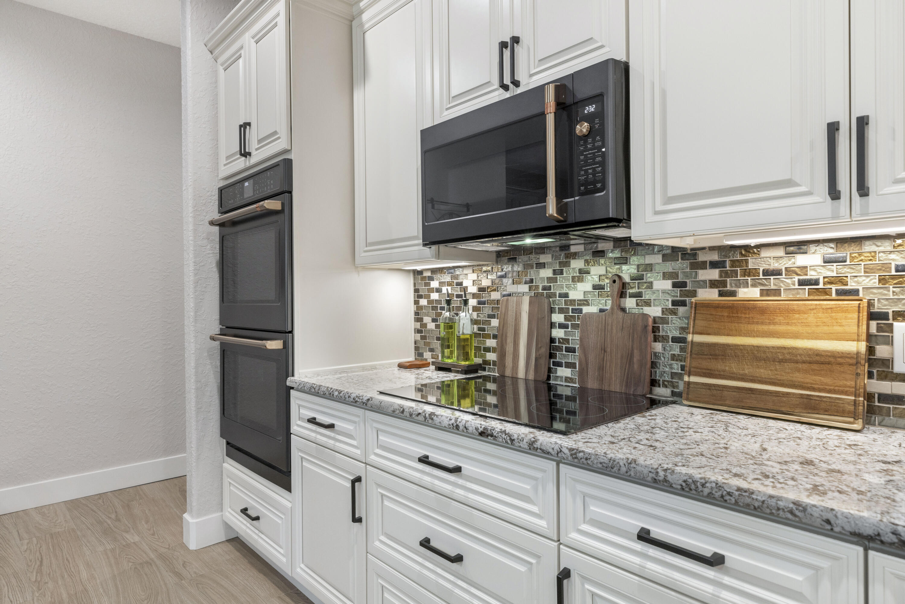 4544 Celestial Drive Grant Valkaria, FL 32949 - Photo 15 of 73 a kitchen with granite countertop white cabinets and stainless steel appliances