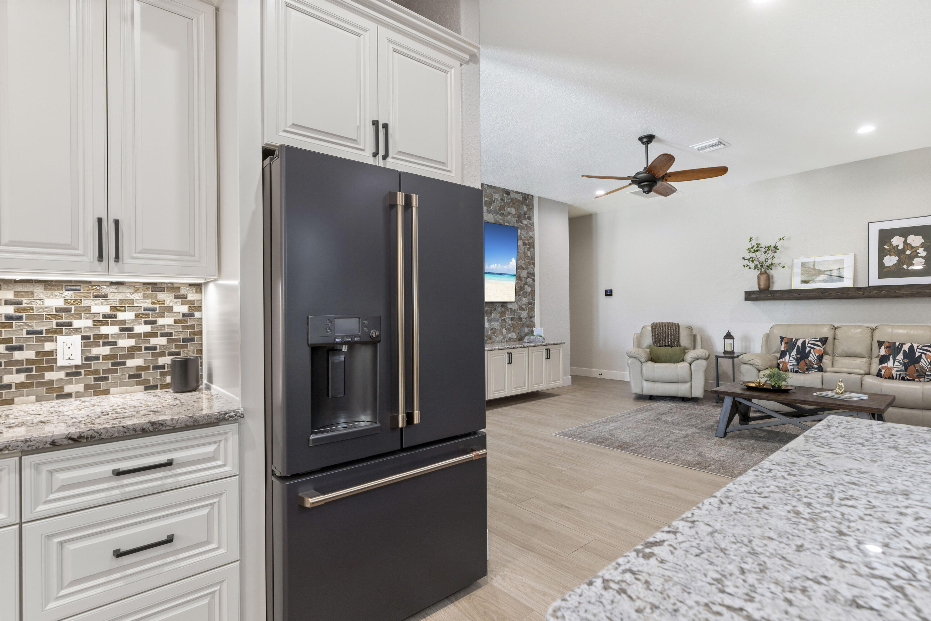 4544 Celestial Drive Grant Valkaria, FL 32949 - Photo 16 of 73 a kitchen with stainless steel appliances granite countertop a refrigerator and a stove top oven