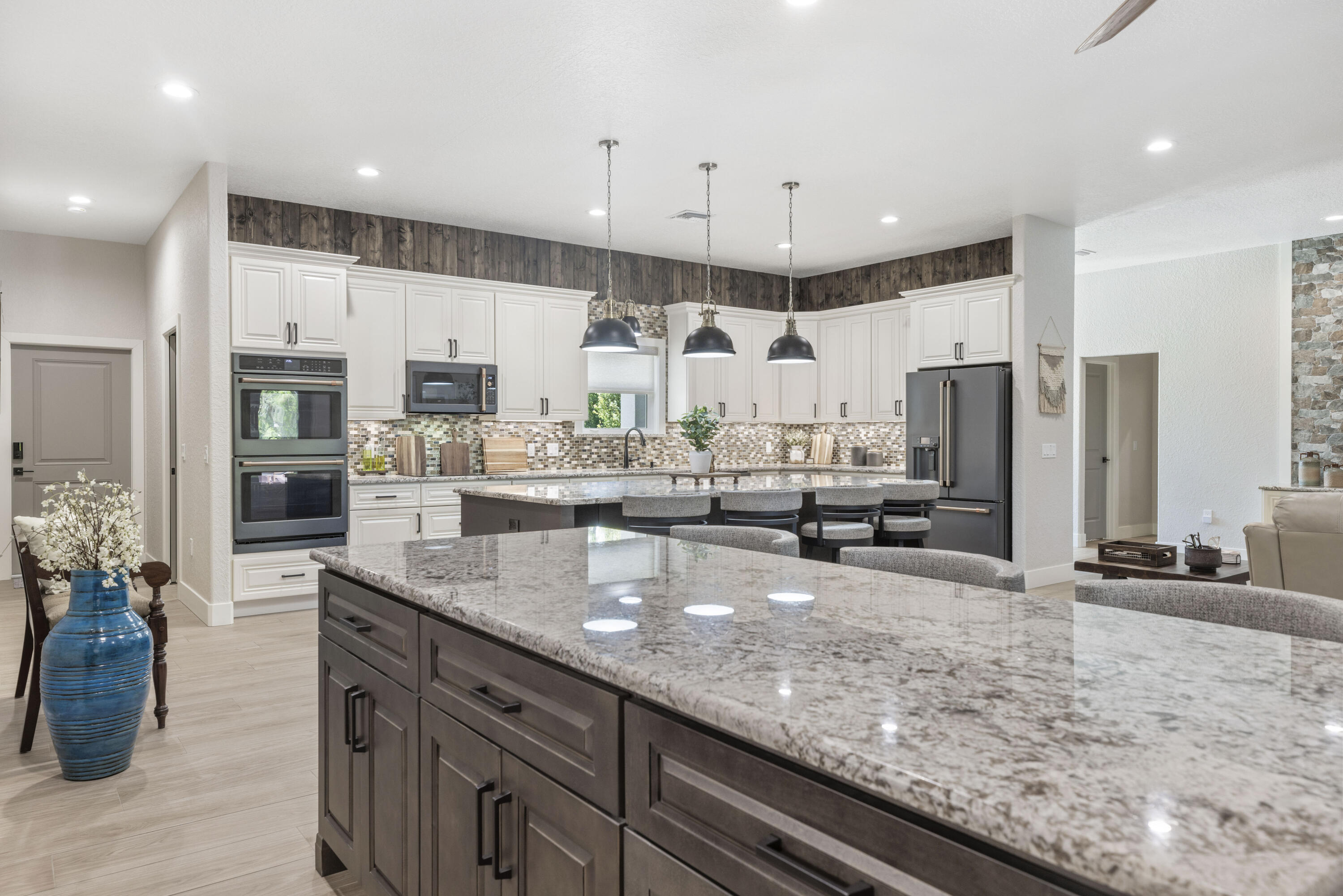 4544 Celestial Drive Grant Valkaria, FL 32949 - Photo 22 of 73 a kitchen with stainless steel appliances granite countertop a sink a stove and a refrigerator