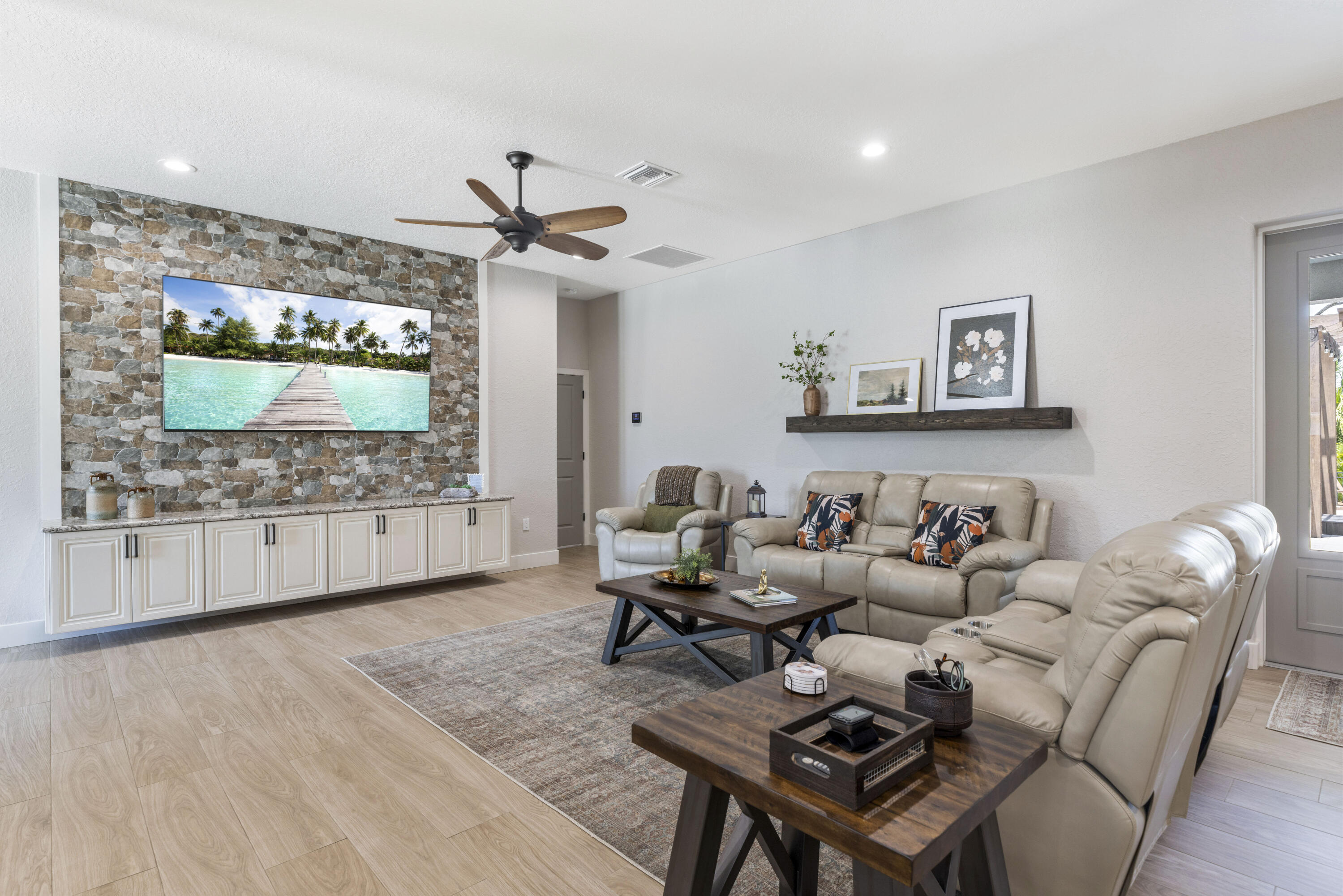 4544 Celestial Drive Grant Valkaria, FL 32949 - Photo 25 of 73 a living room with furniture a flat screen tv and a floor to ceiling window