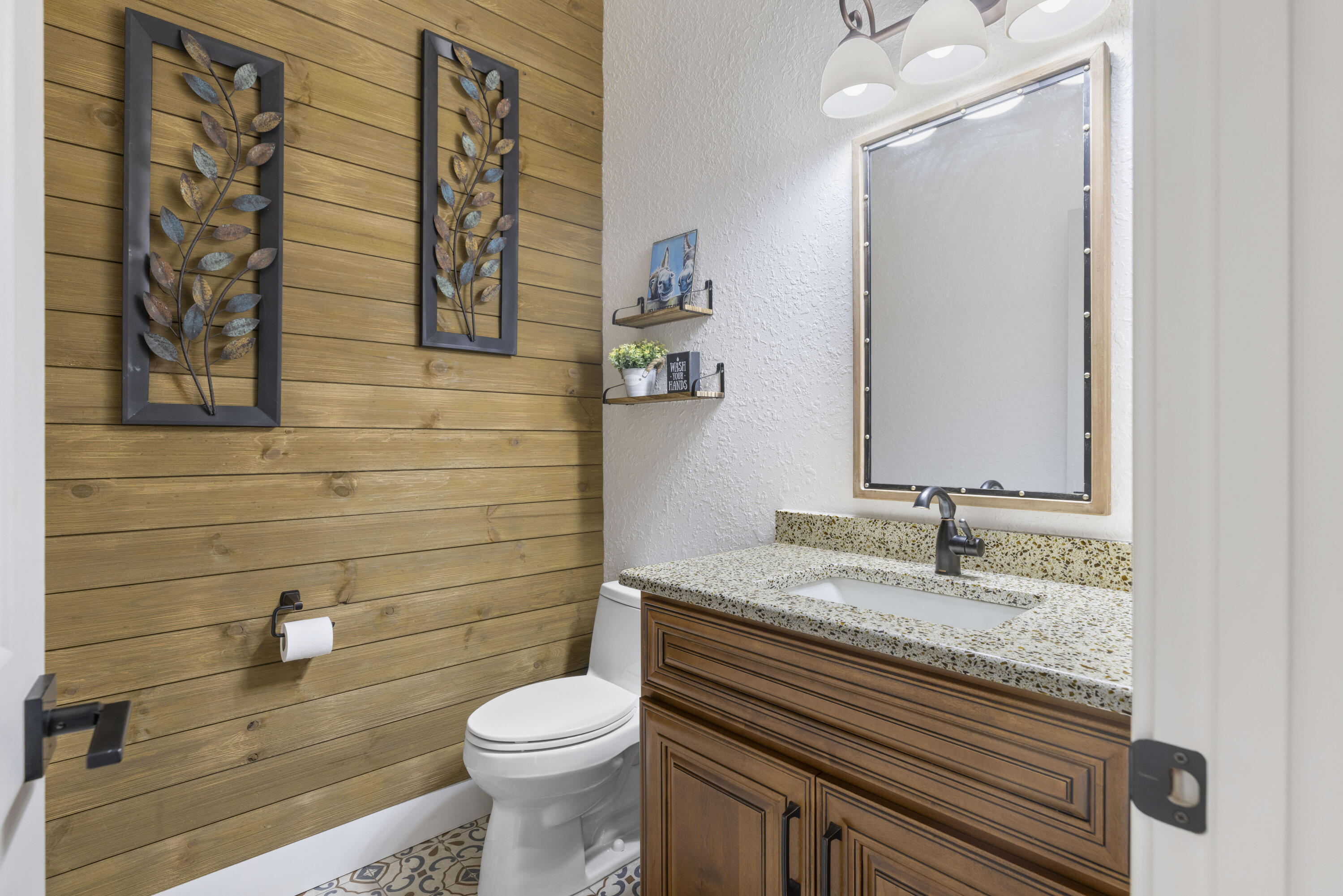 4544 Celestial Drive Grant Valkaria, FL 32949 - Photo 29 of 73 a bathroom with a granite countertop toilet sink and mirror
