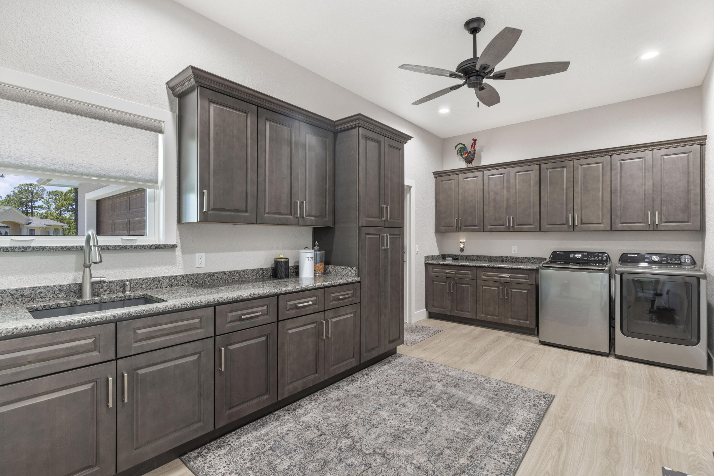 4544 Celestial Drive Grant Valkaria, FL 32949 - Photo 30 of 73 a kitchen with stainless steel appliances granite countertop a sink a stove and a refrigerator