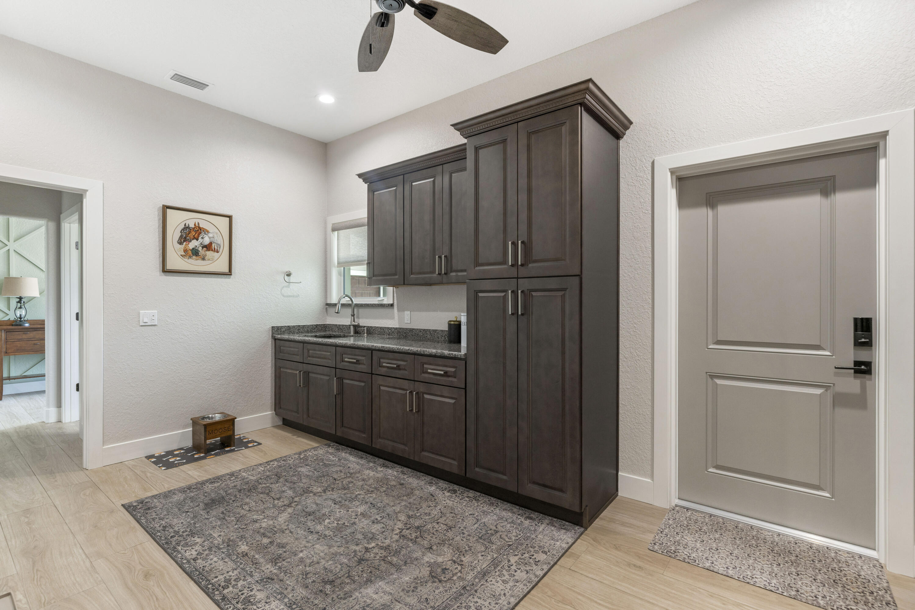 4544 Celestial Drive Grant Valkaria, FL 32949 - Photo 31 of 73 a kitchen with kitchen island granite countertop cabinets and refrigerator
