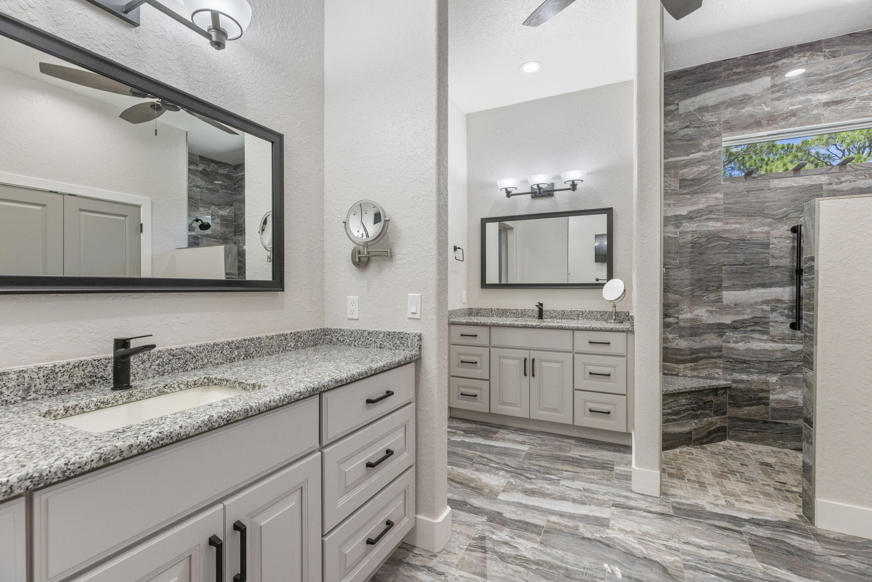 4544 Celestial Drive Grant Valkaria, FL 32949 - Photo 40 of 73 a bathroom with a granite countertop sink vanity and mirror