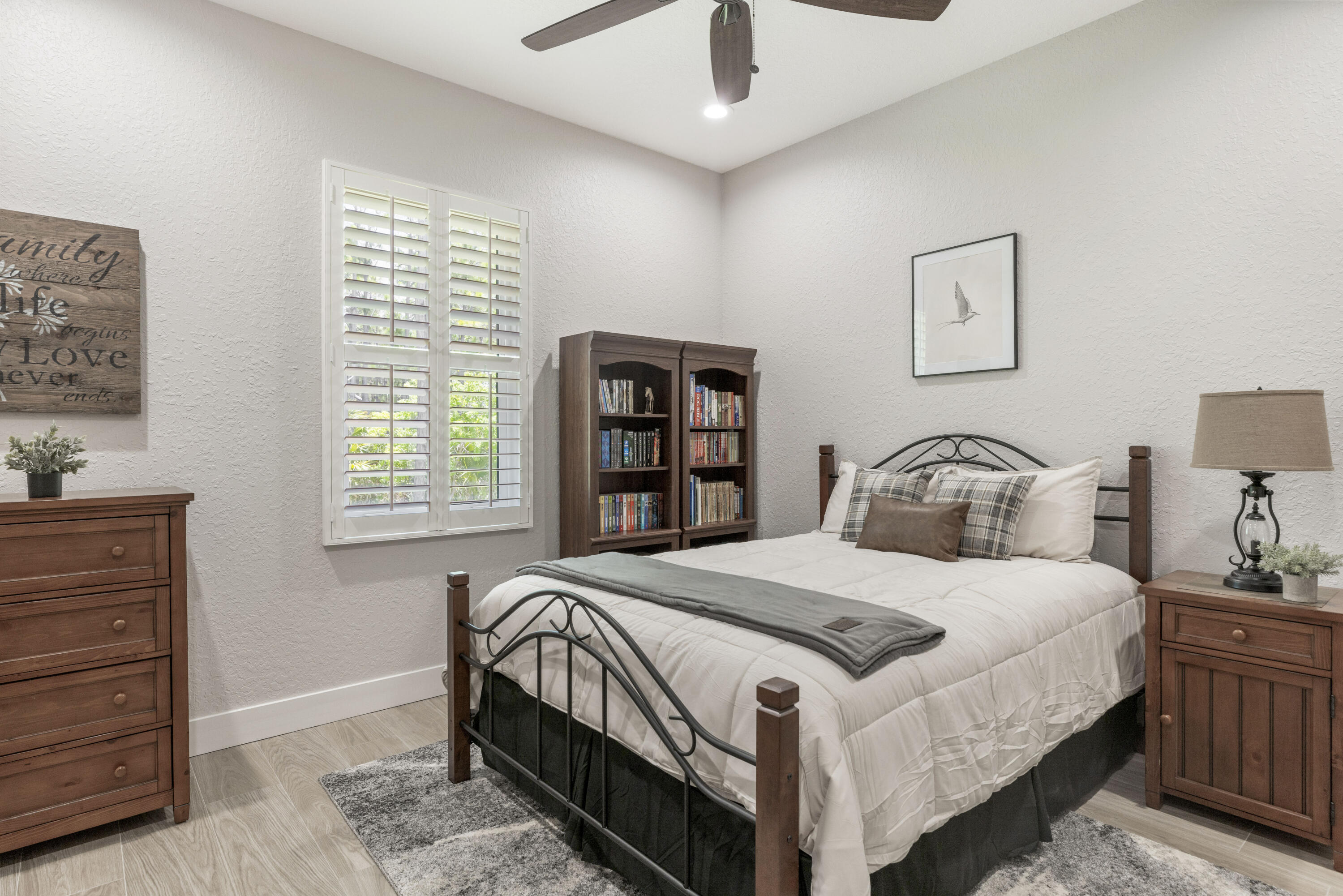 4544 Celestial Drive Grant Valkaria, FL 32949 - Photo 44 of 73 a bedroom with a bed a bookshelf and a window