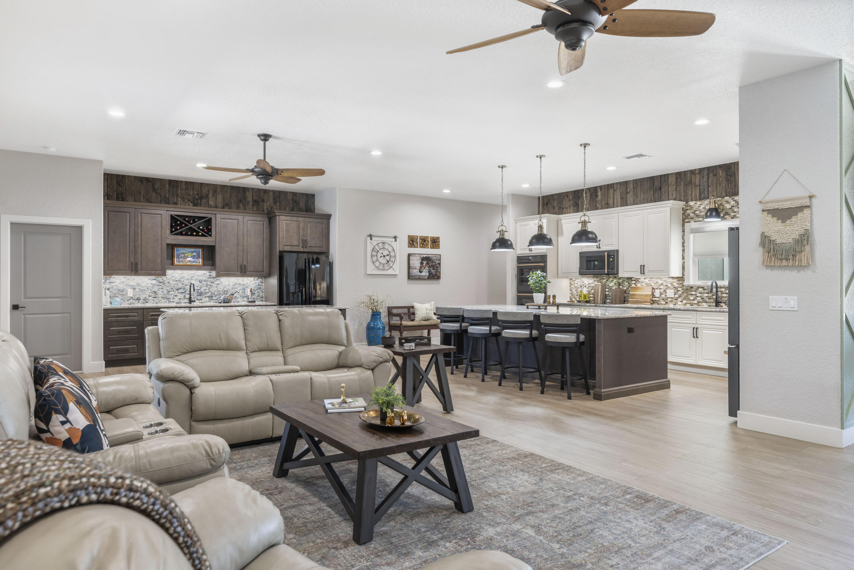 4544 Celestial Drive Grant Valkaria, FL 32949 - Photo 5 of 73 a living room with a couch kitchen view and a chandelier