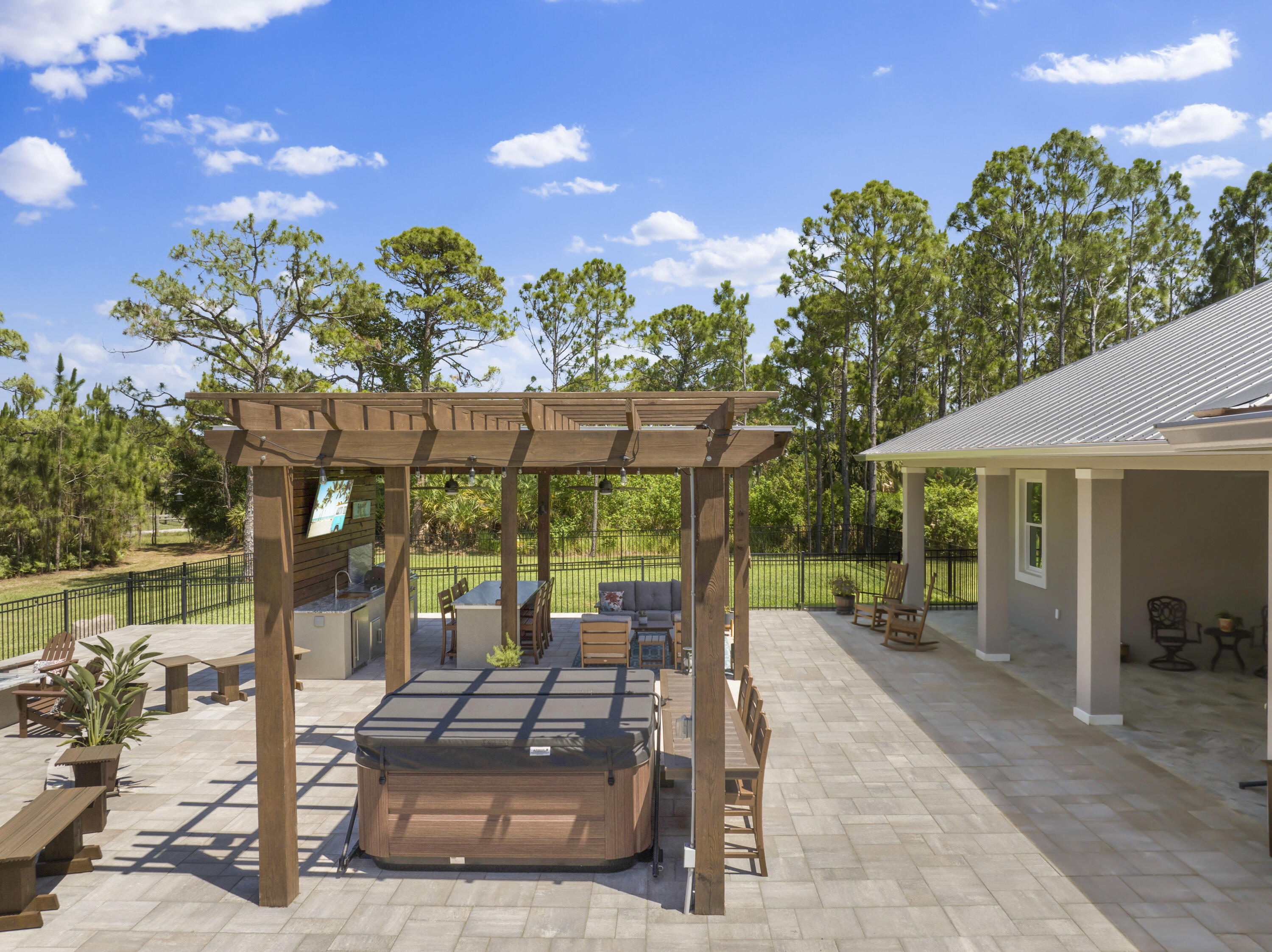 4544 Celestial Drive Grant Valkaria, FL 32949 - Photo 55 of 73 a view of a patio with table and chairs potted plants with wooden floor and fence