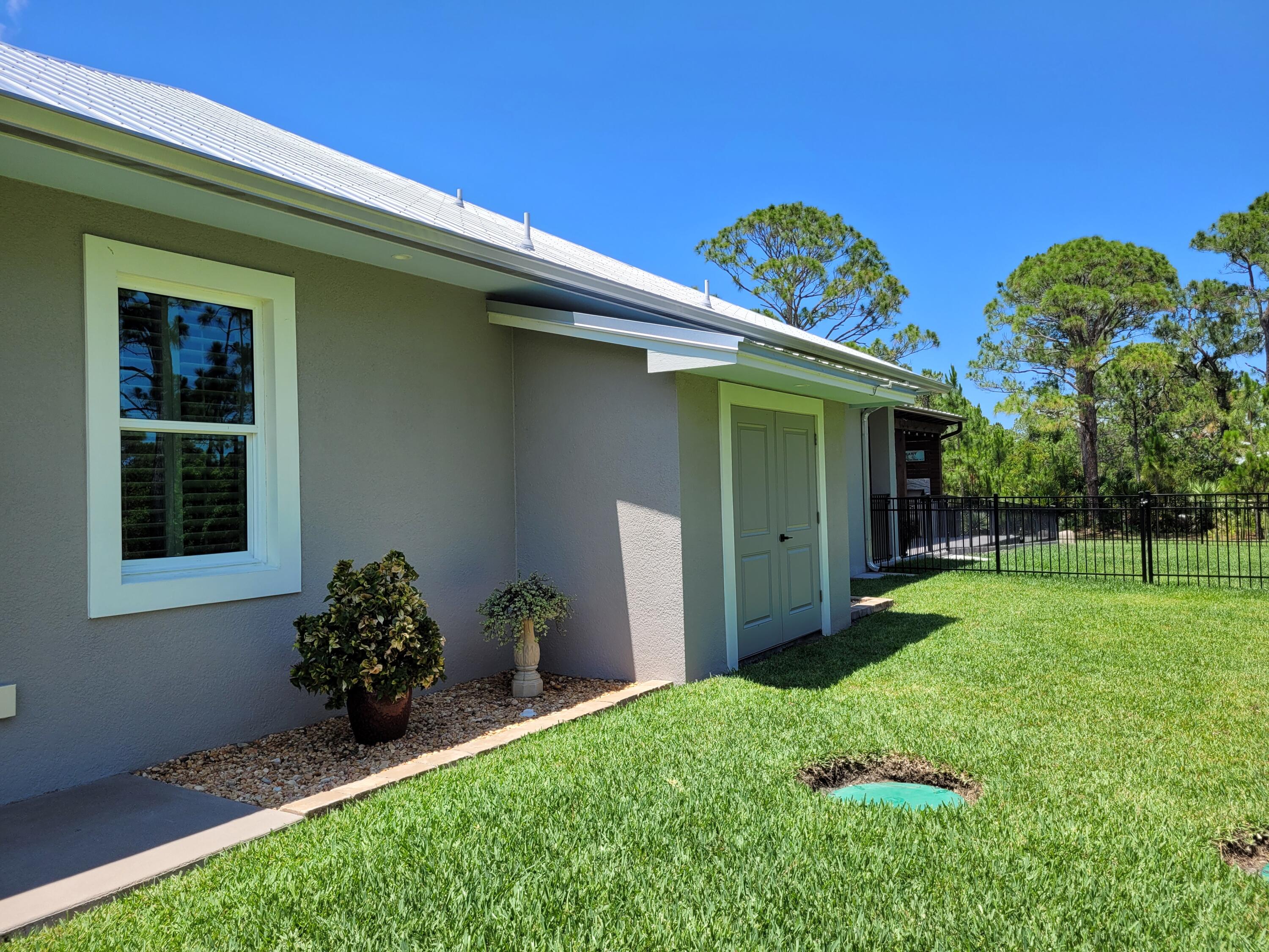 4544 Celestial Drive Grant Valkaria, FL 32949 - Photo 69 of 73 a view of a house with a garden