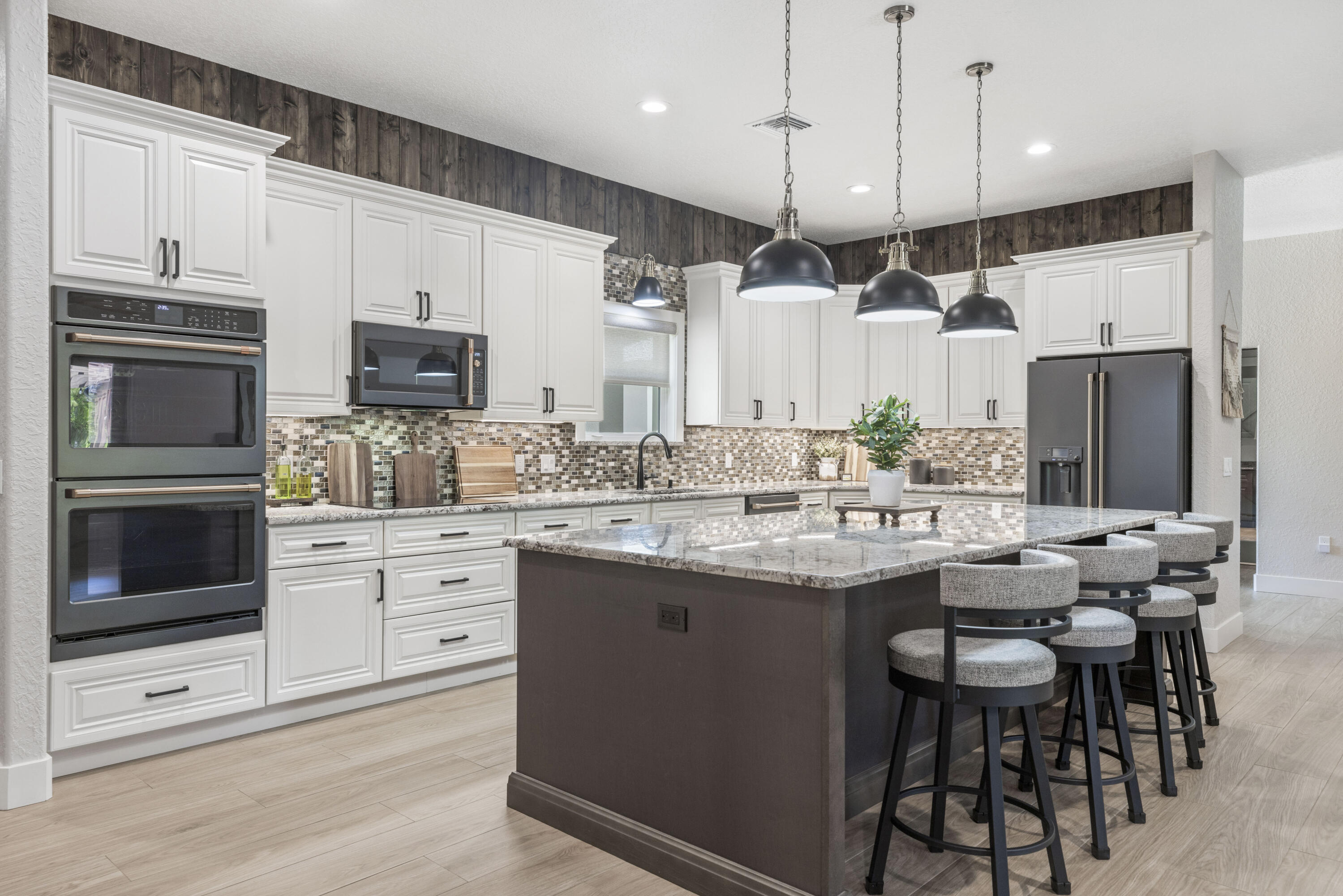 4544 Celestial Drive Grant Valkaria, FL 32949 - Photo 8 of 73 a kitchen with stainless steel appliances kitchen island granite countertop a sink stove and refrigerator